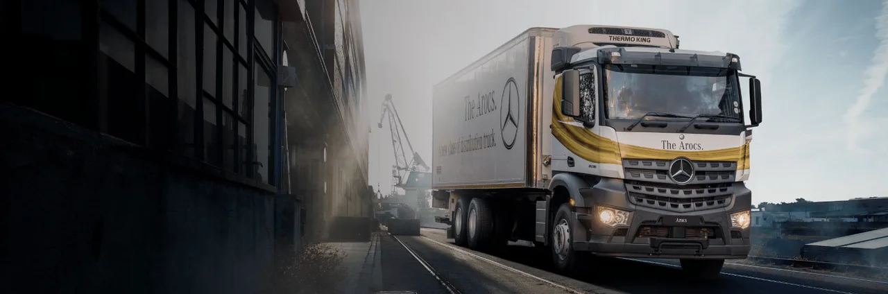Mercedes-Benz Arocs distribution truck travelling on a coastal road